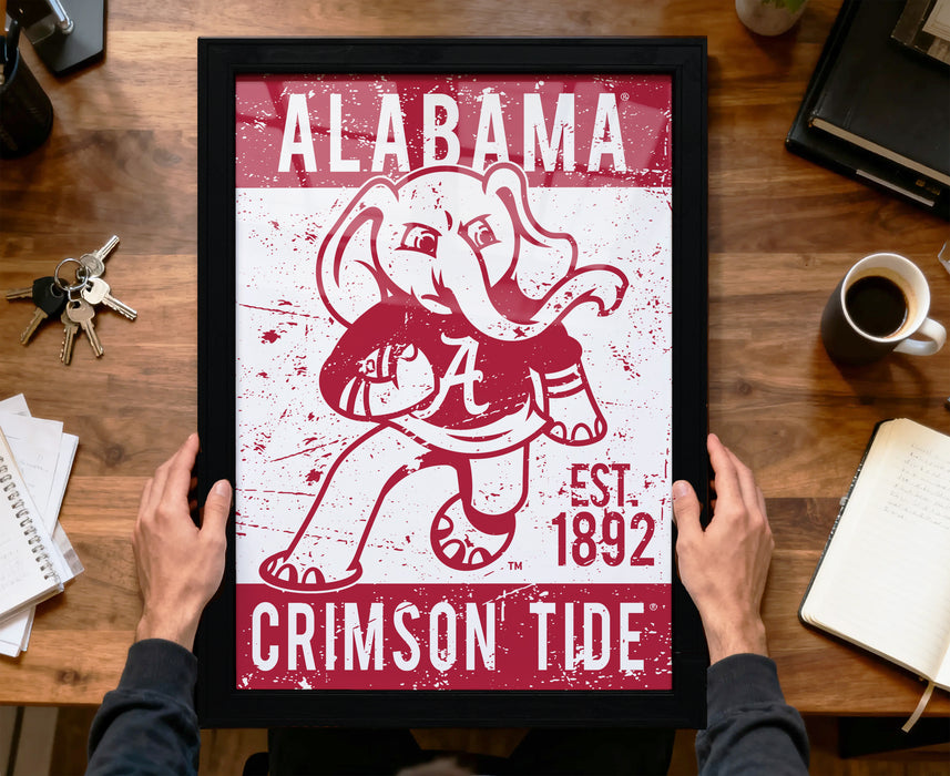A framed poster of an elephant holding a football, with the text "ALABAMA CRIMSON TIDE EST. 1892" printed on it.