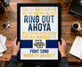 A framed poster with text and a Marquette University logo, held by a person's hands.