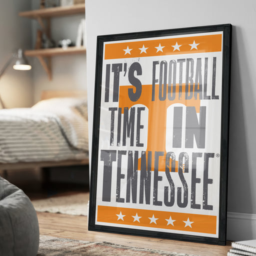 A framed poster with the text "IT'S FOOTBALL TIME IN TENNESSEE" and white stars on an orange background.