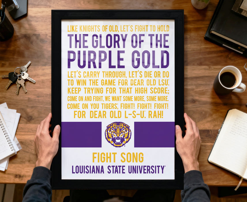 A framed poster with text and a tiger logo, held by a person's hands.