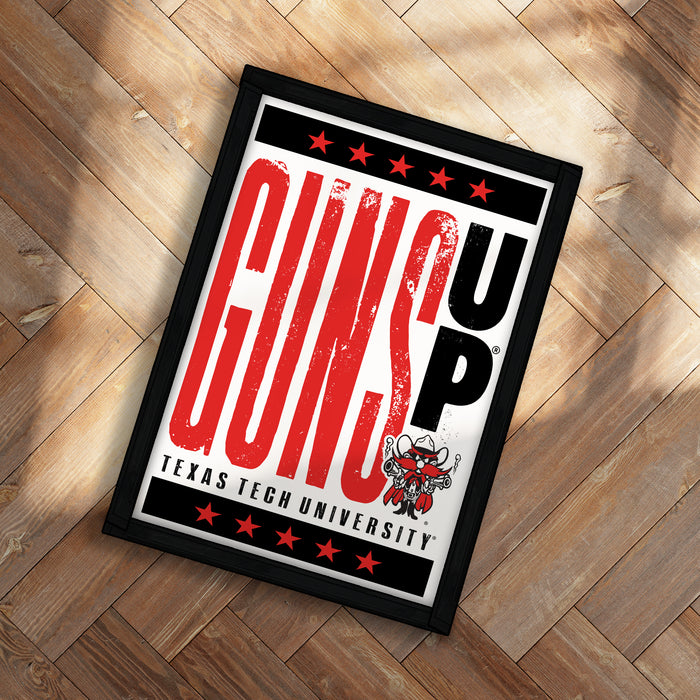 A framed poster with the text "GUN UP" and a graphic of a cowboy on a wooden floor.