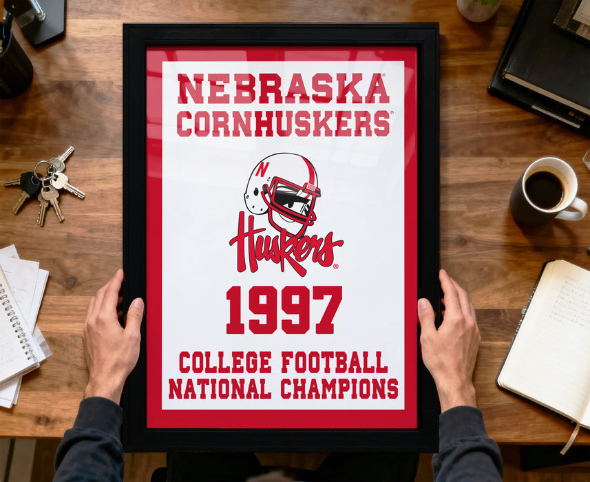 A framed picture of the Nebraska Cornhuskers, a football team, celebrating their 1997 College Football National Champions.