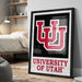 A framed poster of the University of Utah logo is displayed on a wall in a bedroom.