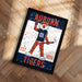 a framed poster of an illustration of a tiger mascot, representing the Auburn Tigers, with the text "Auburn" and "TIGERS" prominently displayed.
