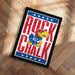 A framed poster featuring the text "ROCK CHALK" and an illustration of a bird, likely representing a sports team or mascot.