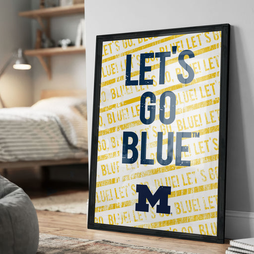 A framed poster with the text "LET'S GO BLUE M" printed on it, which appears to be a motivational message related to a sports team.