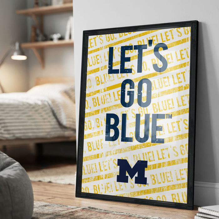 A framed poster with the text "LET'S GO BLUE M" printed on it, which appears to be a motivational message related to a sports team.