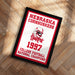 A framed poster celebrating the 1997 Nebraska Cornhuskers college football national championship, featuring the team's logo and text.