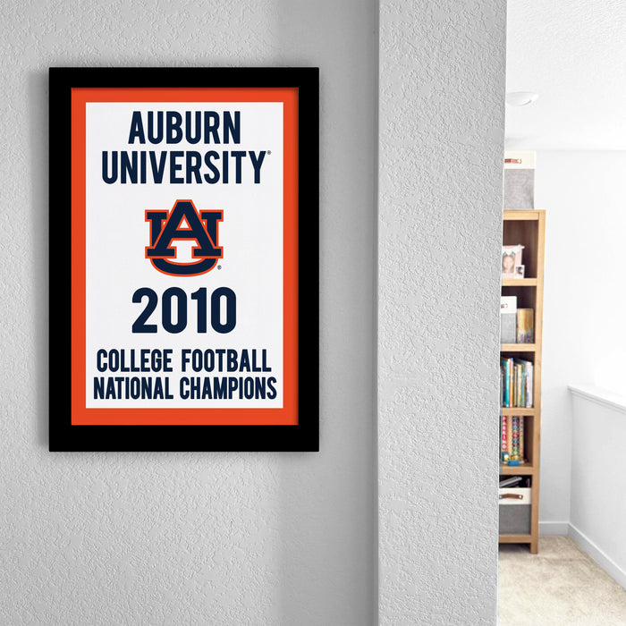 The image is a framed poster hanging on a wall, celebrating Auburn University's 2010 College Football National Champions.