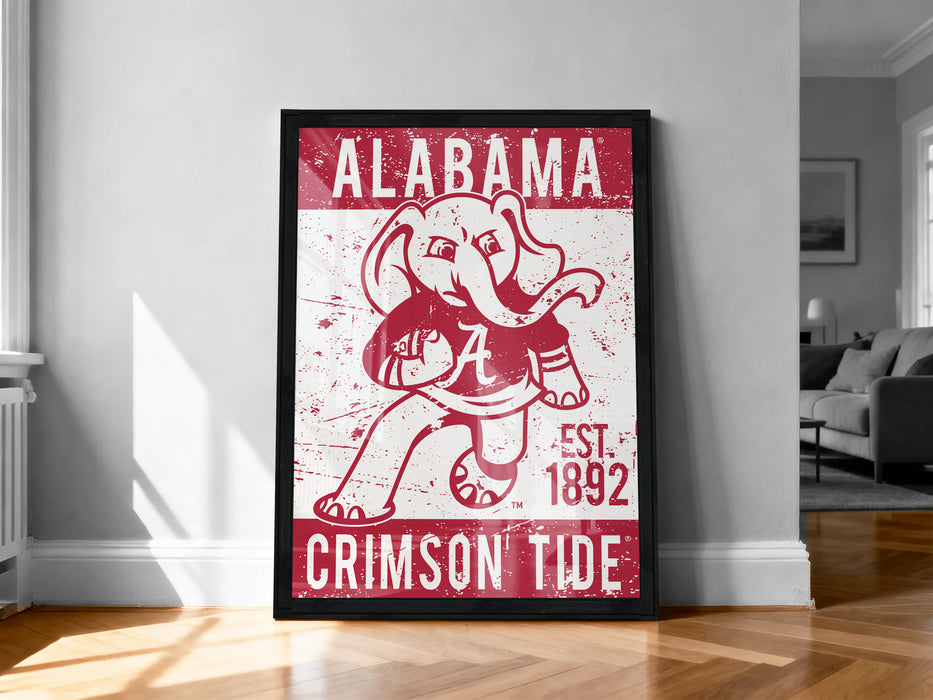 A framed poster of the Alabama Crimson Tide football team, featuring the team's mascot in a dynamic pose.