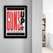a framed poster with the text "GUNS UP" and "TEXAS TECH UNIVERSITY" printed on it, hanging on a wall.