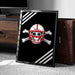A framed poster with a skull and crossbones design, featuring a football helmet, is displayed on a carpeted floor next to a wooden chest.