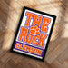 A framed poster with the text "THE ROCK CLAMS" and an orange paw print, representing the University of South Carolina's football team.