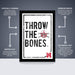 The image is a poster featuring the text "THROW THE BONES" with a skull and crossbones symbol. The poster is described as "OFFICIALLY LICENSED" and "PREMIUM PRINTED", indicating that it is a professionally printed poster. The poster is also described as "SHIPPED FLAT" and "ALL POSTERS ARE SHIPPED FOR EASY Folding and in boxes that are easy to gift wrap."
