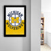a framed poster of the Michigan Wolverines, a sports team, hanging on a wall.