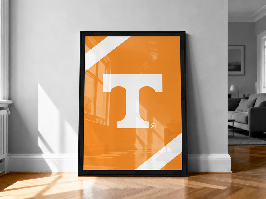 a large orange poster with a white "T" on it, displayed on a wall in a room with a wooden floor.