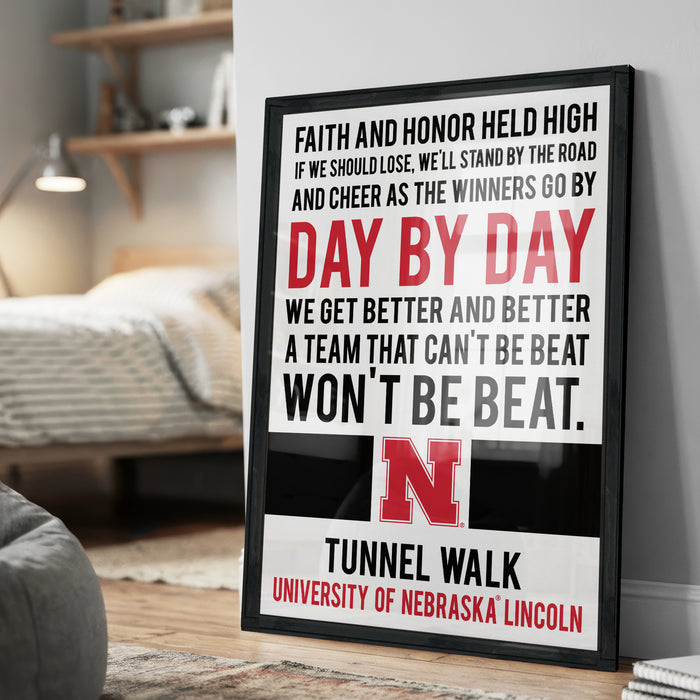 a framed poster with motivational text, including a quote about Nebraska football and the University of Nebraska Lincoln.