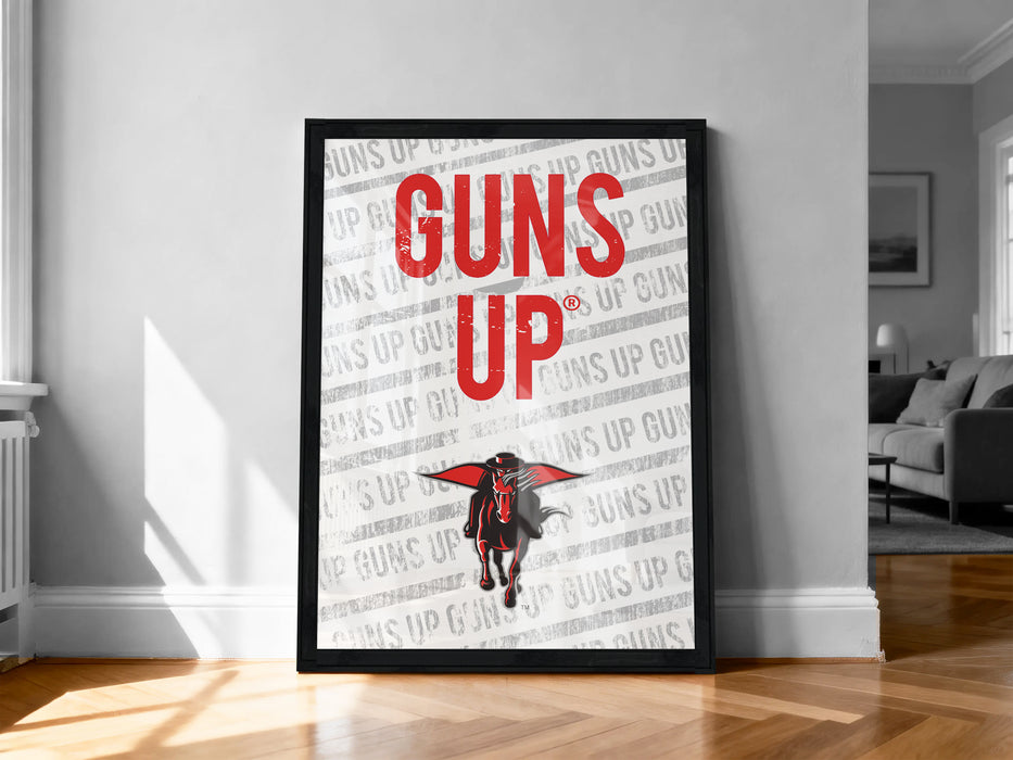 A framed poster with the text "GUNS UP" prominently displayed, along with a graphic of a person in a red cape.