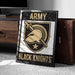 A framed poster with the text "ARMY BLACK KNIGHTS" and a graphic of a helmet and sword, placed on a carpeted floor next to a wooden chest.