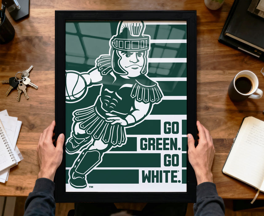 A framed poster featuring a cartoon character holding a basketball, with the text "GO GREEN. GO WHITE." displayed below the image.