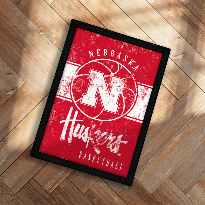 A framed poster with the text "Nebraska Huskers Basketball" on it, featuring the logo of the Nebraska Huskers basketball team.