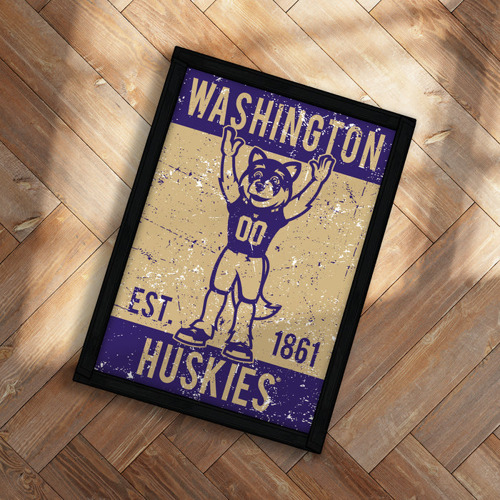 A framed poster featuring a cartoon image of a mascot with the text "WASHINGTON EST. 1861 HUSKIES" on it.