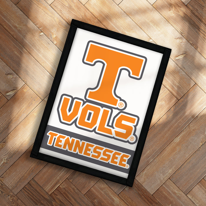 A framed poster with the word "TENNESSEE" printed on it, placed on a wooden floor.
