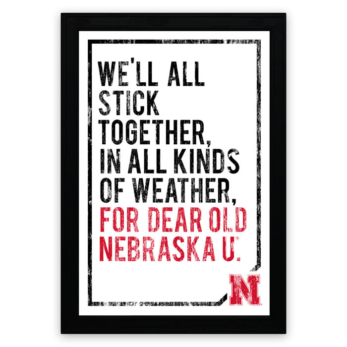 a framed poster with a motivational quote in bold text, which reads "WE'LL ALL STICK TOGETHER, IN ALL KINDS OF WEATHER, FOR DEAR OLD NEBRASKA U."