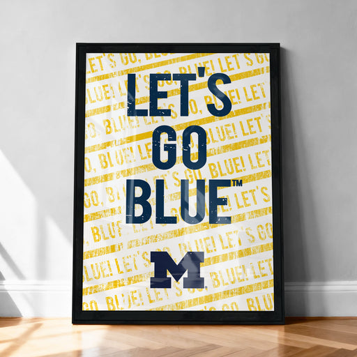 A framed poster with the text "LET'S GO BLUE! LET'S GO" printed on it, along with the letters "BLUE! LET'S" repeated multiple times in a yellow and black pattern.