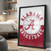A framed poster of the Alabama basketball team logo is displayed on a wall in a bedroom.