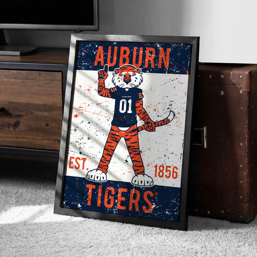 a framed poster of an illustration of a tiger wearing a football jersey with the text "Auburn Tigers" and the year "1856" below it.