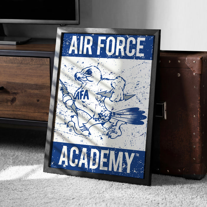 a framed poster with the text "AIR FORCE ACADEMY" and an illustration of a bird, likely representing the Air Force Academy.