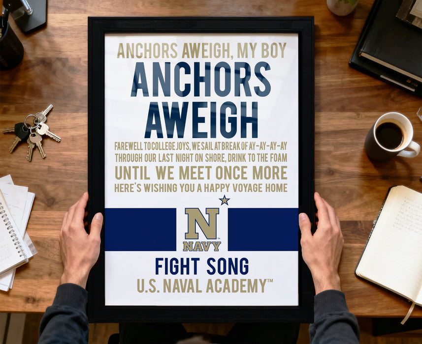 a framed poster with a Navy-themed message, held by a person's hands.