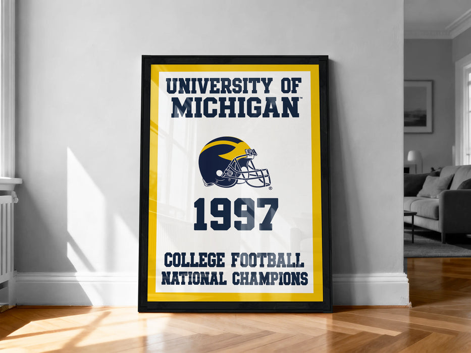 A framed poster on a wall celebrating the University of Michigan's 1997 College Football National Champions.