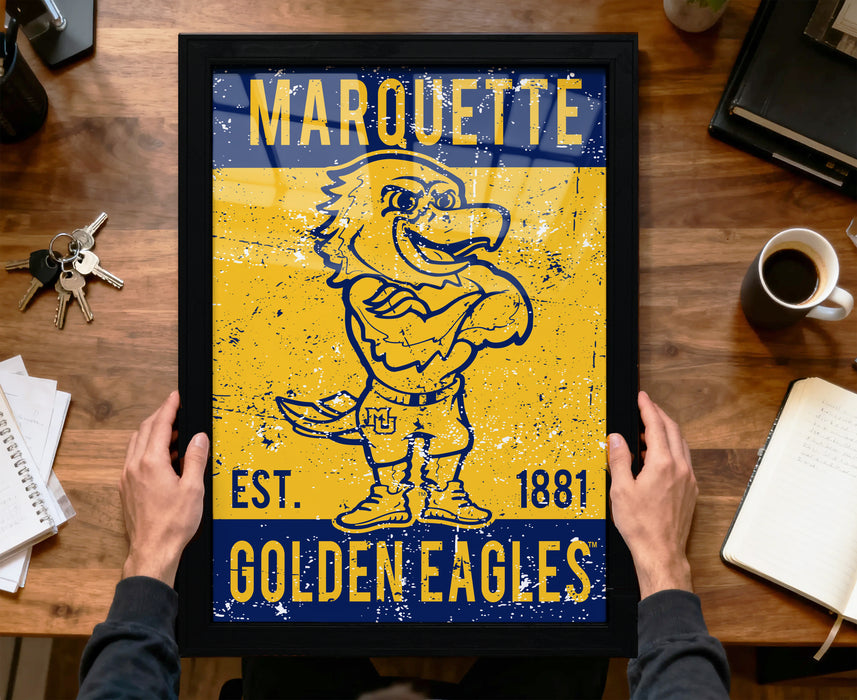 A framed poster of a mascot for Marquette University, featuring a yellow and blue design with a bird-like character.