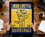 A framed poster of a mascot for Marquette University, featuring a yellow and blue design with a bird-like character.