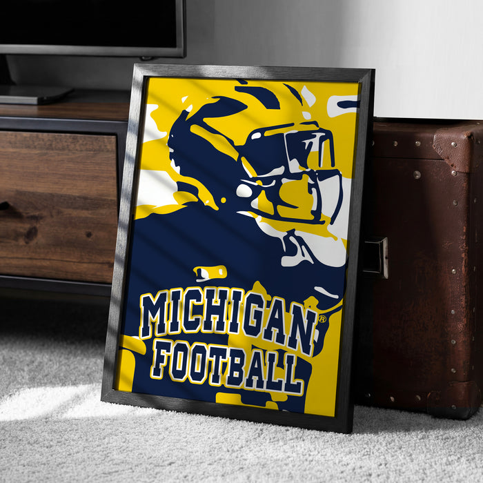 A framed poster of a football player in a Michigan football uniform, with the text "Michigan Football" prominently displayed.