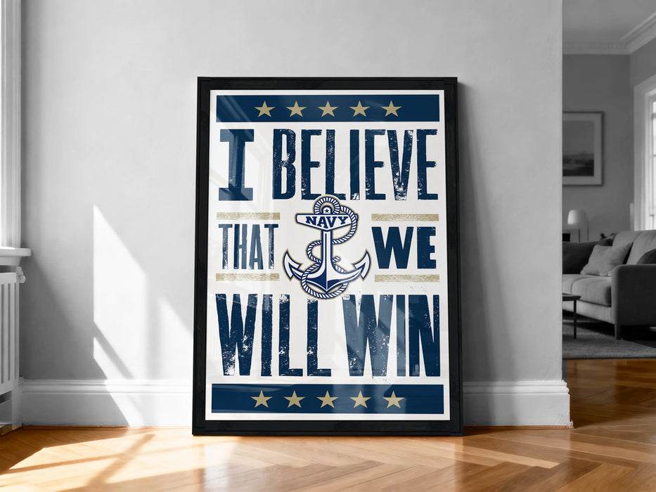 a framed poster with the text "I BELIEVE THAT WE WILL WIN" and an anchor symbol, placed on a wooden floor against a white wall.