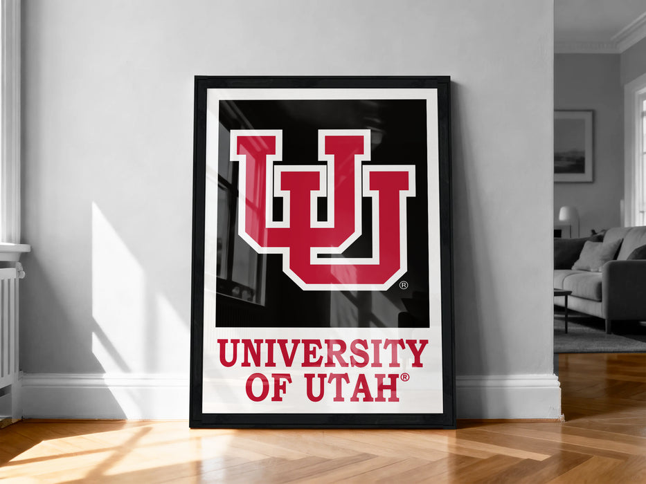 A framed poster of the University of Utah logo is displayed on a wall in a room.