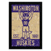 A framed poster featuring a mascot character with raised arms, wearing a jersey with the number 00, and the text "WASHINGTON EST. 1861 HUSKIES" in a distressed, vintage style.