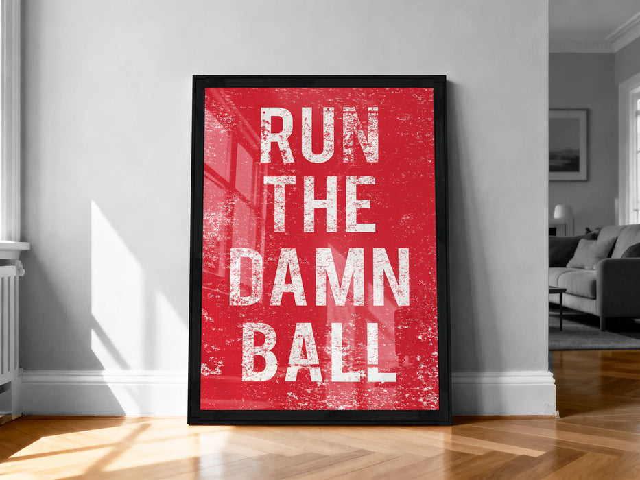A framed poster with the text "RUN THE DAMN BALL" in bold white letters against a red background.
