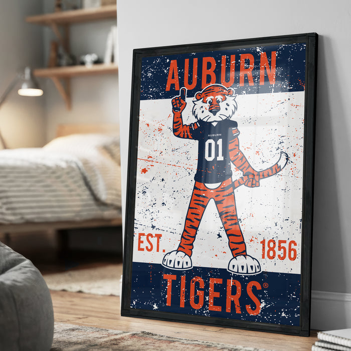 a framed poster of an animated tiger character, likely representing the Auburn Tigers, with the text "Auburn" and "Est. 1856" prominently displayed.