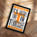 A framed poster with the text "IT'S FOOTBALL TIME IN TENNESSEE" printed on it, placed on a wooden floor.