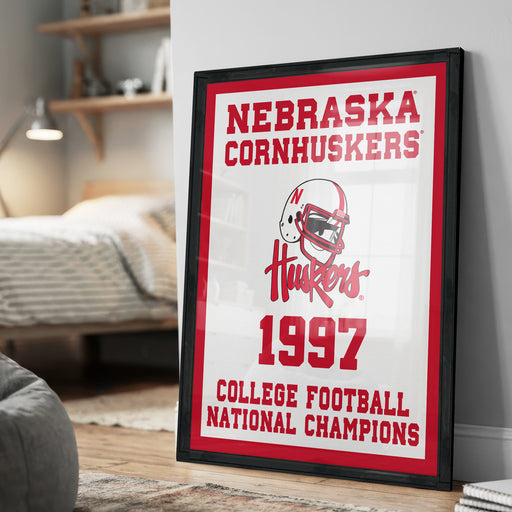 A framed poster on a wall celebrating the 1997 Nebraska Cornhuskers College Football National Champions.