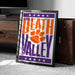 A framed poster with the text "Welcome to Death Valley" and an orange paw print graphic, placed on a carpeted floor next to a wooden chest.