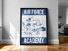 a framed poster with the text "AIR FORCE ACADEMY" and an illustration of a bird, likely representing the Air Force Academy.