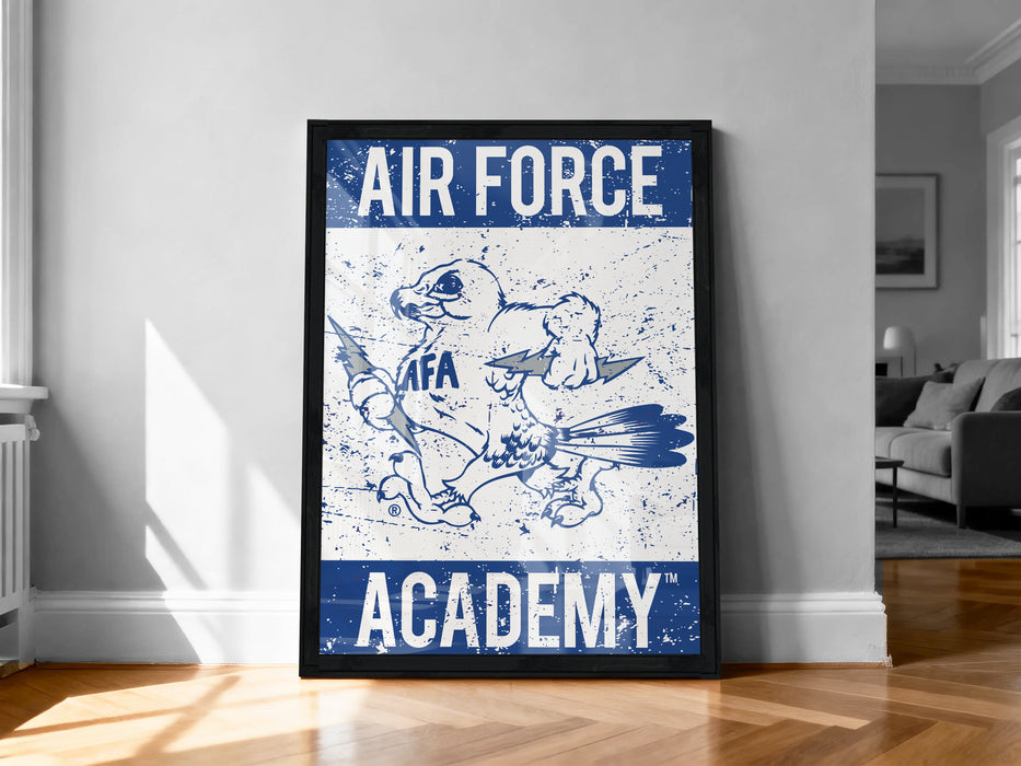 a framed poster with the text "AIR FORCE ACADEMY" and an illustration of a bird, likely representing the Air Force Academy.