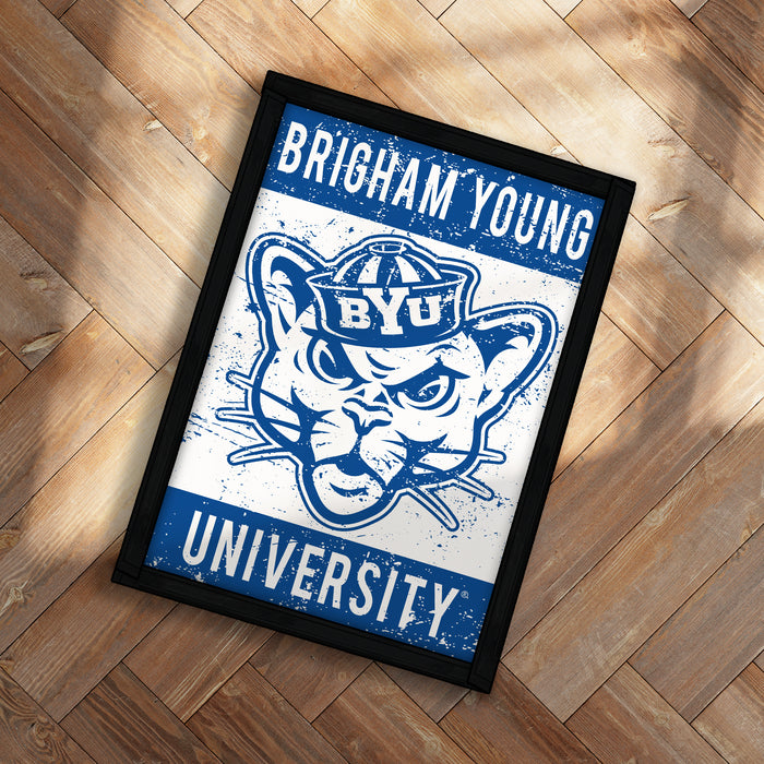 A framed poster with the text "BRIGHAM YOUNG" and "BYU UNIVERSITY" on it, featuring a stylized cat logo.