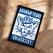 A framed poster with the text "BRIGHAM YOUNG" and "BYU UNIVERSITY" on it, featuring a stylized cat logo.