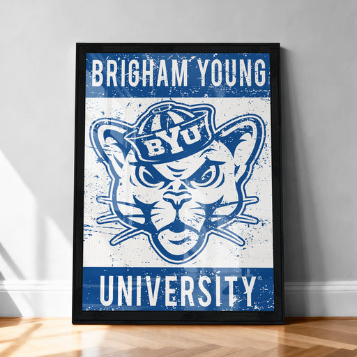 A framed poster with the text "BRIGHAM YOUNG UNIVERSITY" and an illustration of a cat wearing a hat.